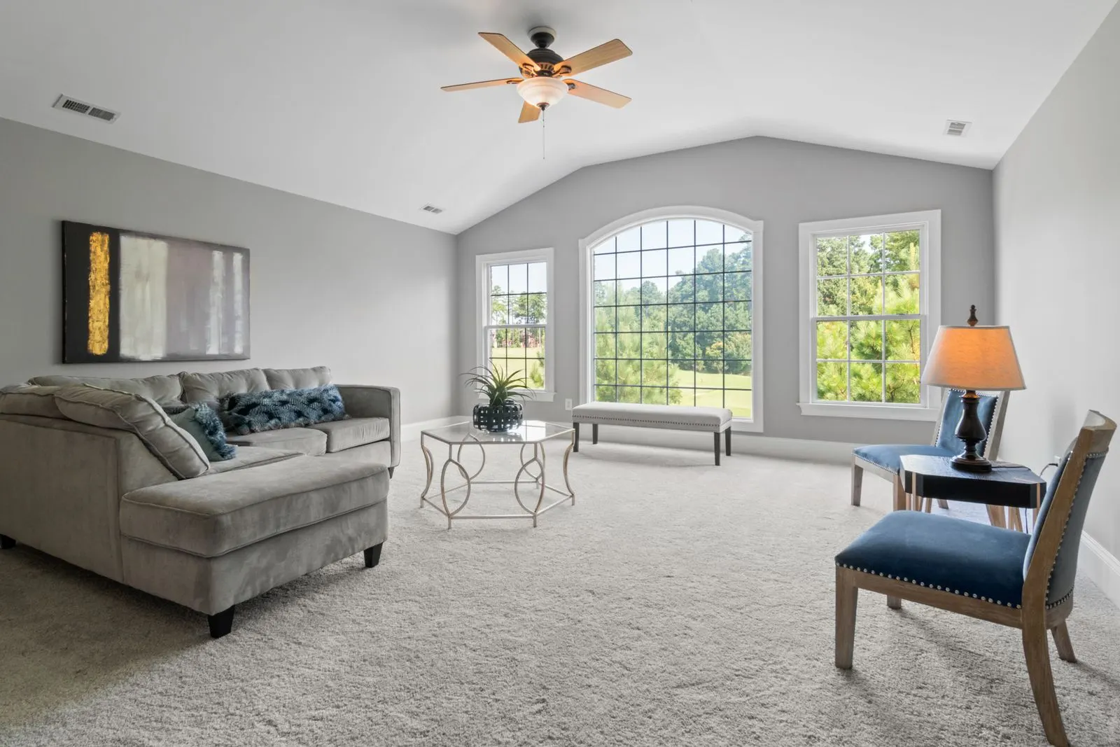 Ceiling fan with a light kit in a bright living room